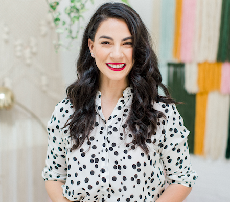 Claire Ashley, beauty expert, smiling in a white blouse with black polka dots.
